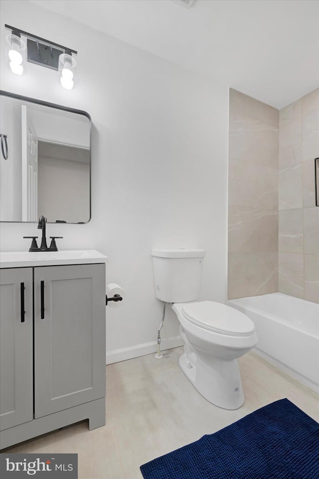 full bathroom featuring toilet, vanity, and tiled shower / bath