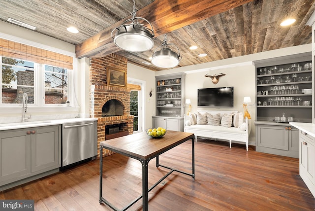 living room featuring dark wood finished floors, wooden ceiling, indoor wet bar, and a fireplace