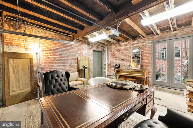 office space with brick wall, french doors, and concrete floors