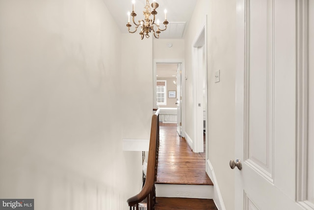 hallway with baseboards and wood finished floors