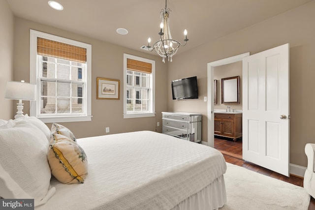 bedroom featuring visible vents, baseboards, dark wood-style floors, a sink, and a notable chandelier