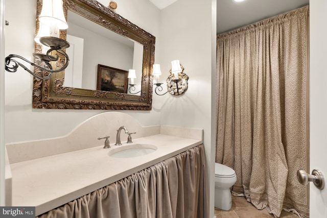 full bath with vanity, toilet, and tile patterned floors