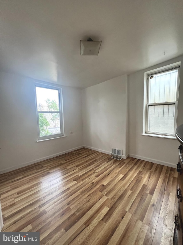 unfurnished room with light hardwood / wood-style flooring