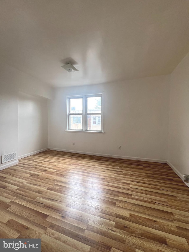 spare room with light hardwood / wood-style flooring