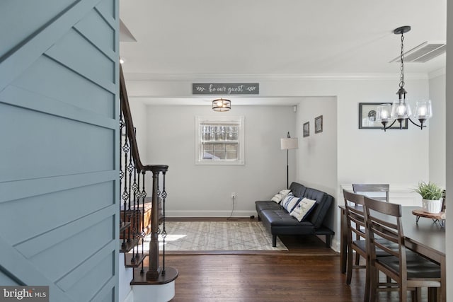 interior space with a notable chandelier, baseboards, stairs, ornamental molding, and dark wood-style floors