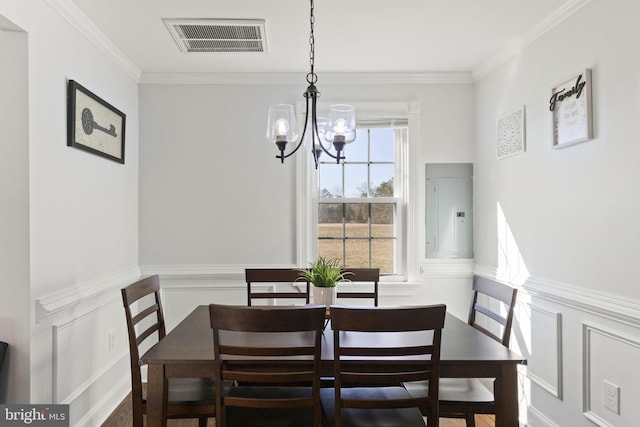 dining room featuring a wainscoted wall, visible vents, an inviting chandelier, ornamental molding, and electric panel