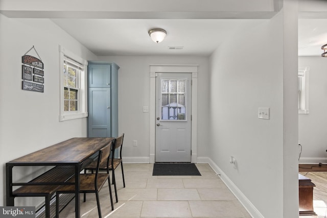 entryway featuring visible vents, a wealth of natural light, and baseboards