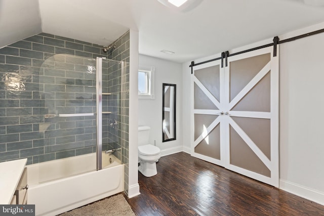 bathroom featuring baseboards, toilet, shower / tub combination, wood finished floors, and vanity