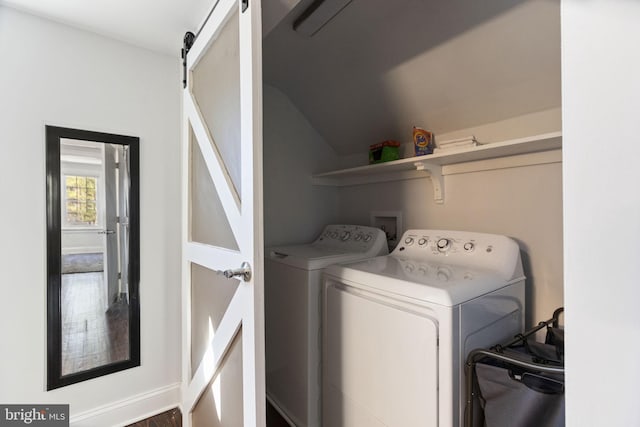 laundry area with a barn door and washing machine and clothes dryer