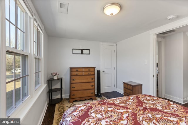 bedroom featuring dark wood-style floors, baseboards, and visible vents