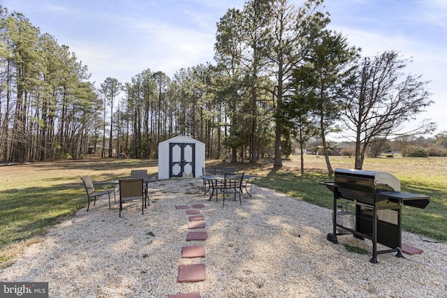 view of patio with a grill, a storage unit, and an outdoor structure