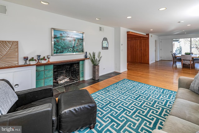 living room featuring hardwood / wood-style flooring and a fireplace