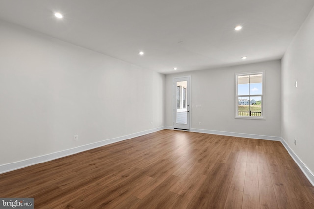 empty room with hardwood / wood-style flooring