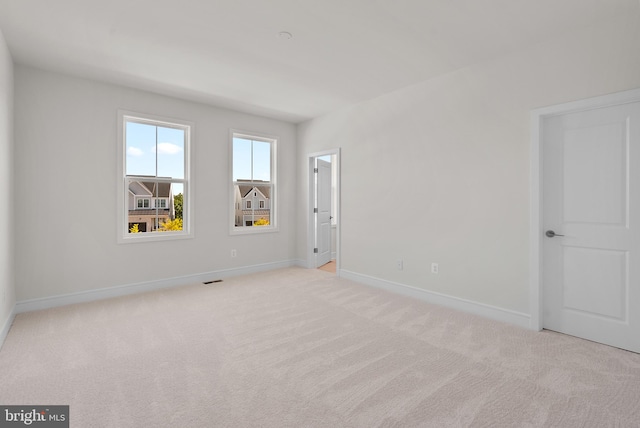 empty room featuring light colored carpet