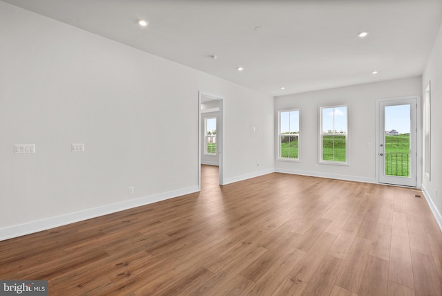 spare room with light hardwood / wood-style flooring