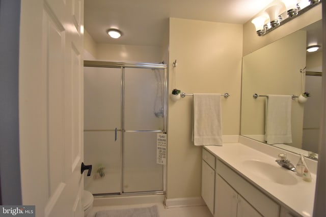 bathroom with a stall shower and vanity