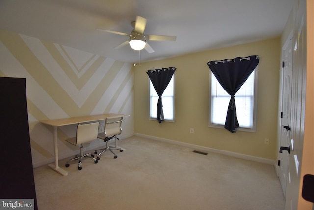 unfurnished office featuring carpet floors, wallpapered walls, baseboards, and visible vents