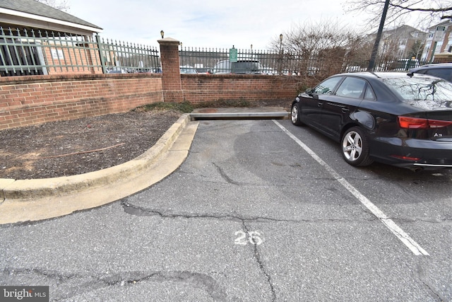 uncovered parking lot featuring fence