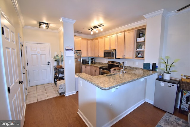 kitchen featuring light stone counters, light brown cabinetry, appliances with stainless steel finishes, ornamental molding, and a sink