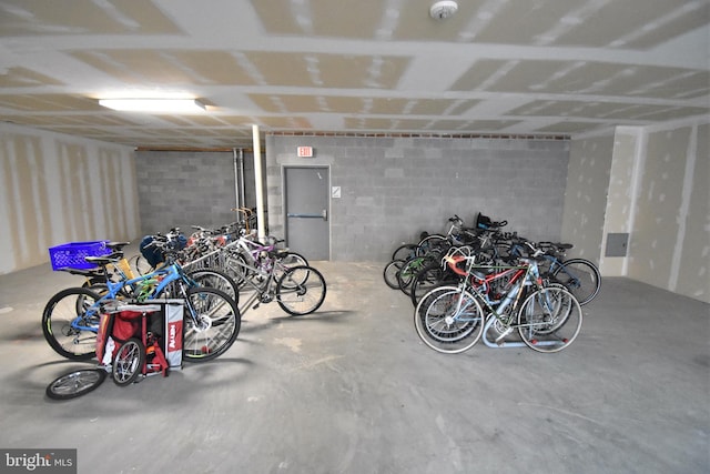 garage featuring concrete block wall and bike storage