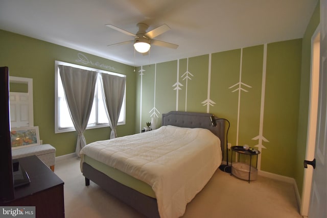 carpeted bedroom featuring a ceiling fan and baseboards