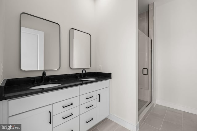 bathroom featuring vanity, a shower with shower door, and tile patterned floors