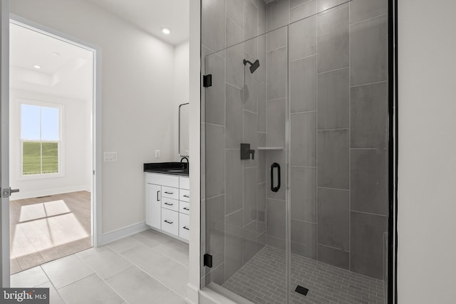 bathroom featuring tile patterned flooring, vanity, and walk in shower