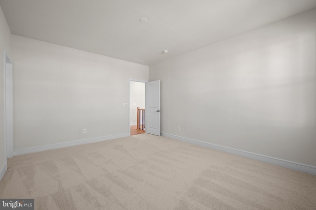 unfurnished room featuring light colored carpet