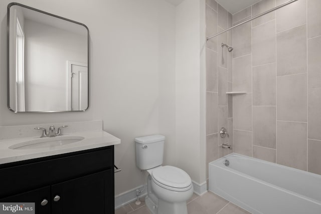 full bathroom featuring toilet, tile patterned flooring, vanity, and tiled shower / bath