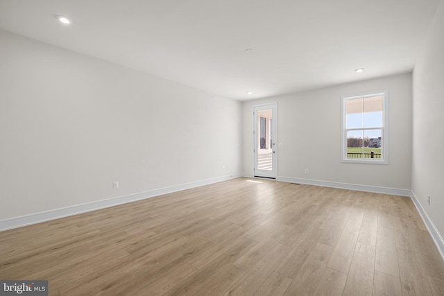 spare room with light hardwood / wood-style flooring