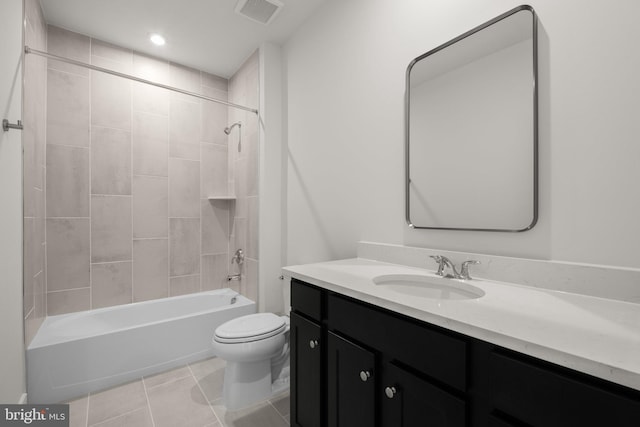 full bathroom with tiled shower / bath combo, vanity, tile patterned flooring, and toilet