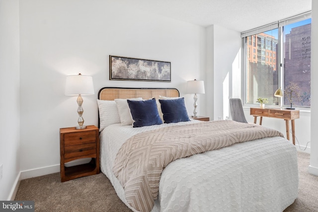 bedroom featuring baseboards and carpet flooring