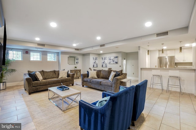 living area with light tile patterned floors, baseboards, visible vents, and recessed lighting