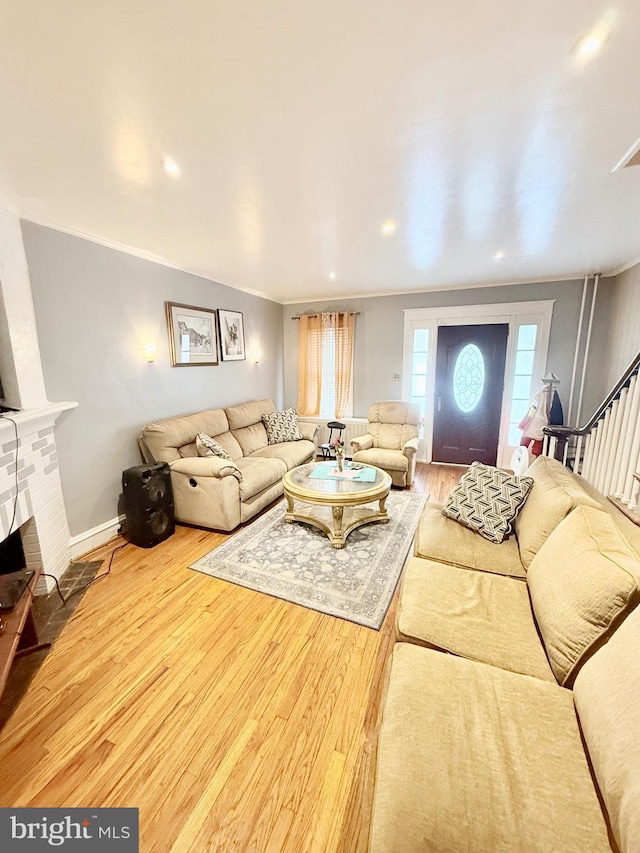 living room with ornamental molding and wood-type flooring