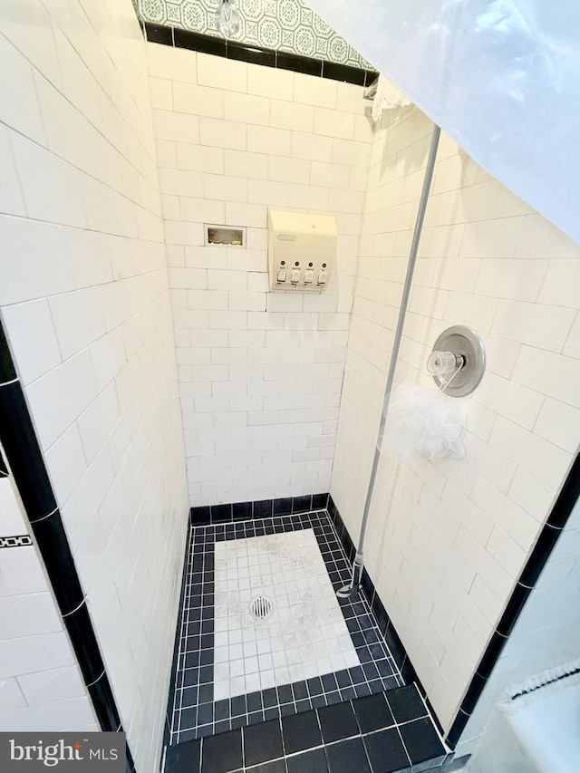 bathroom with tiled shower