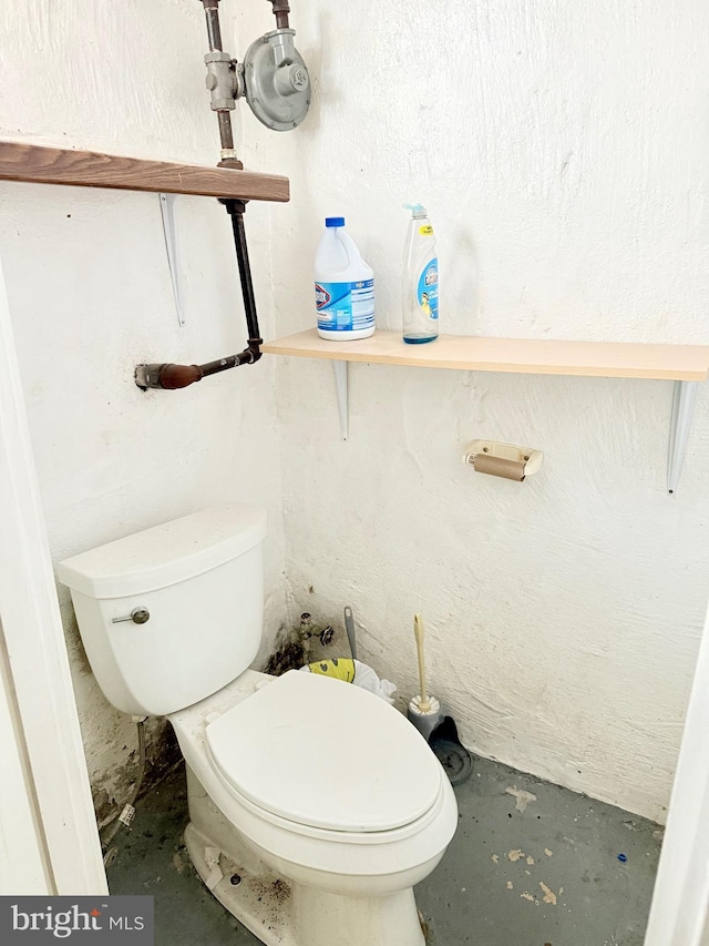 bathroom featuring toilet and concrete floors