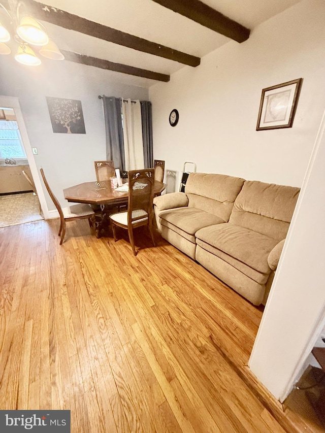 living room with wood-type flooring and beam ceiling