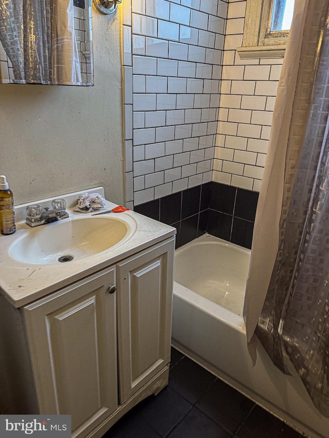 full bath featuring shower / bath combo, vanity, and tile patterned floors