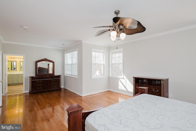 bedroom with crown molding, light wood-style flooring, and baseboards