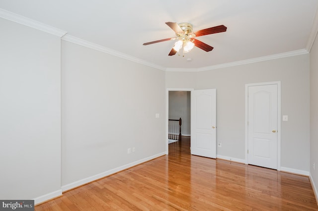 unfurnished bedroom with crown molding, baseboards, and wood finished floors