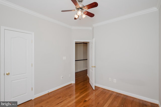 unfurnished bedroom with baseboards, ornamental molding, and light wood-style floors