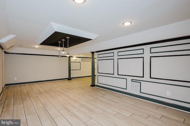 cinema featuring baseboards, a tray ceiling, recessed lighting, and light wood-style floors