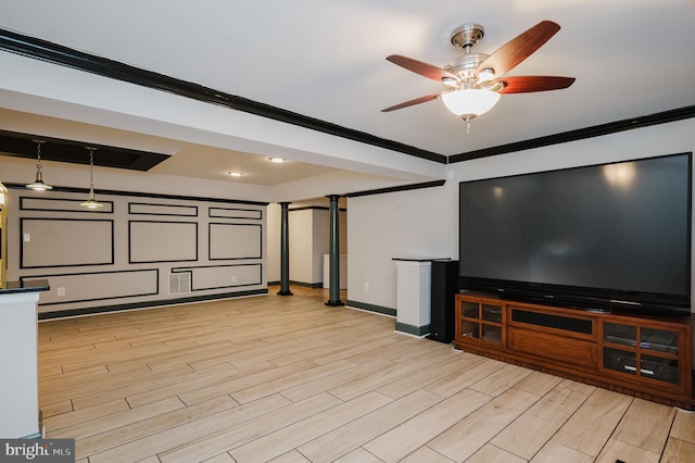 cinema room with ornamental molding, baseboards, light wood finished floors, and a ceiling fan