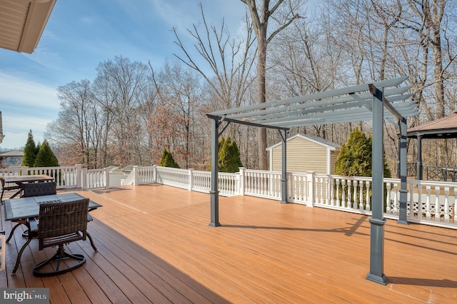 deck with outdoor dining area and a pergola