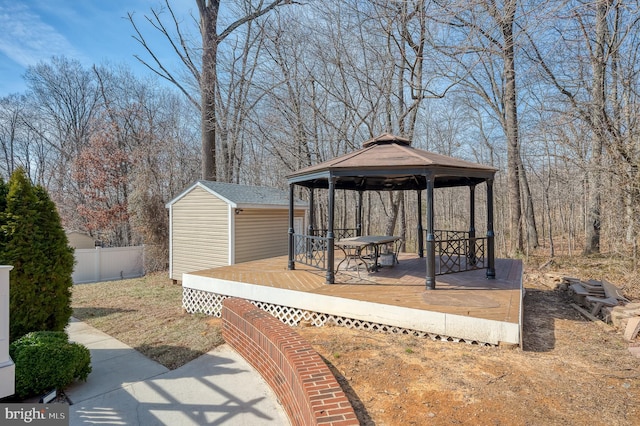 wooden deck featuring a gazebo and fence