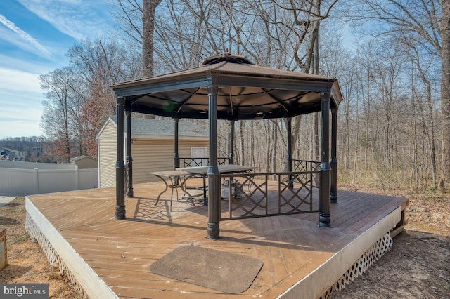 wooden deck featuring fence, outdoor dining area, and a gazebo