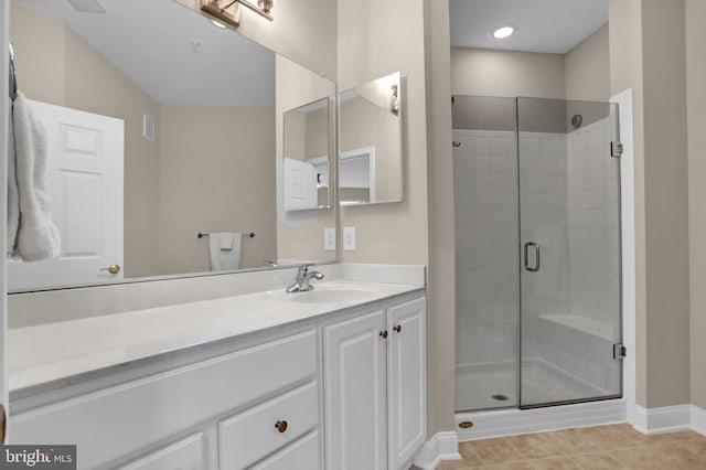 full bathroom with baseboards, a shower stall, vanity, and tile patterned floors