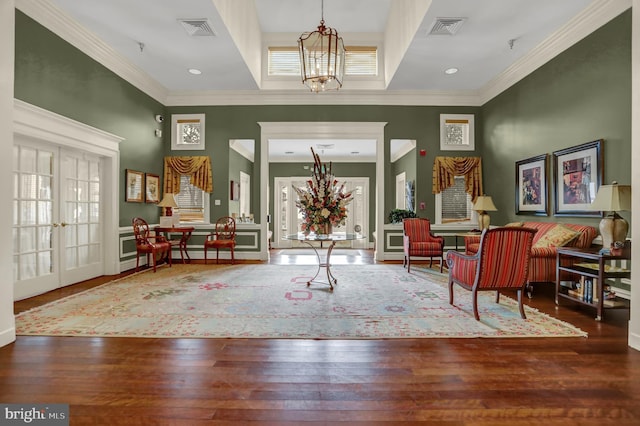 foyer entrance featuring hardwood / wood-style floors, french doors, visible vents, and a notable chandelier