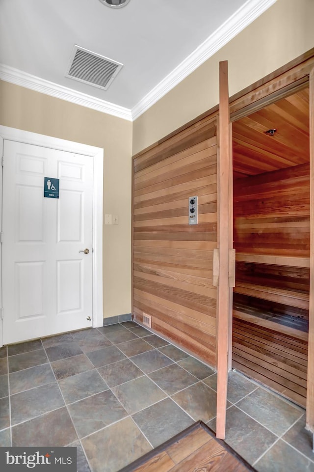 entryway featuring a sauna, ornamental molding, and visible vents