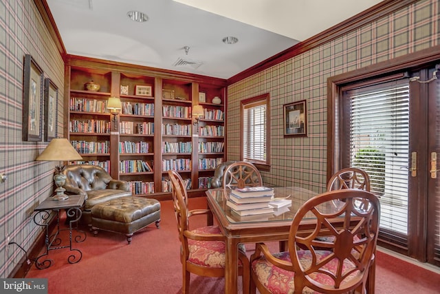 dining area featuring carpet floors, ornamental molding, visible vents, and wallpapered walls